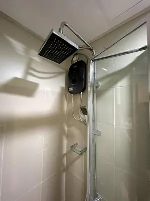 a bathroom with a shower with a laptop on the wall at 1BR Suite near Megamall, Boni & Shaw MRT Station in Manila