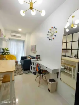 a living room with a desk and a couch at 1BR Suite near Megamall, Boni & Shaw MRT Station in Manila