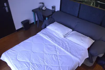 a blue bed with two pillows on top of it at Adorable - Hot tub in Manila