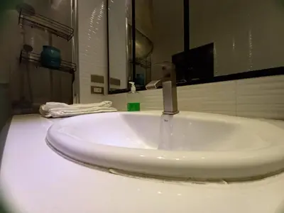 a white sink in a bathroom with a mirror at Adorable - Hot tub in Manila