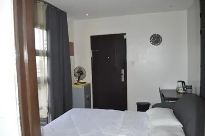 a bedroom with a bed and a black door at Adorable - Hot tub in Manila
