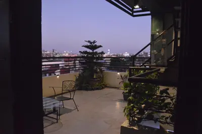 a balcony with chairs and a tree on a building at Adorable - Hot tub in Manila