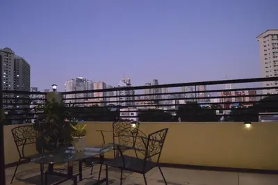 a patio with a table and chairs on a balcony at Adorable - Hot tub in Manila