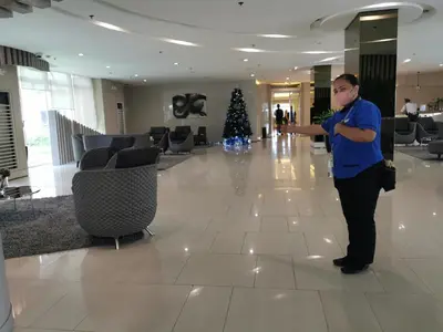 a man standing in the lobby of a hotel at Apad@graceresidences nr BGC in Manila