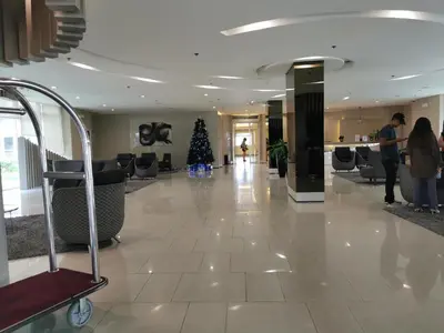 a christmas tree in the middle of a lobby at Apad@graceresidences nr BGC in Manila