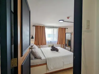 a bedroom with a bed with a bag on it at Budget 1BR Loft Apartment in Cainta Cambridge Village in Cainta