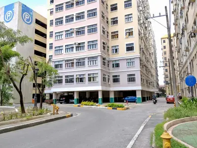 an empty street in front of a tall building at Budget 1BR Loft Apartment in Cainta Cambridge Village in Cainta