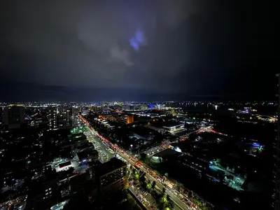 a view of a city at night at Beautiful 1bed condo Nr Airport, MOA, Makati, Bay in Manila