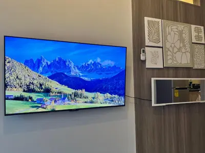 a flat screen tv hanging on a wall at Beautiful 1bed condo Nr Airport, MOA, Makati, Bay in Manila