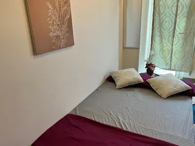 a bed with two pillows on it in a room at Beautiful 1bed condo Nr Airport, MOA, Makati, Bay in Manila