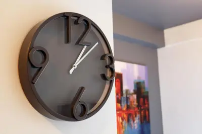 a clock is hanging on a wall at mySTAY Hotel BGC East in Manila