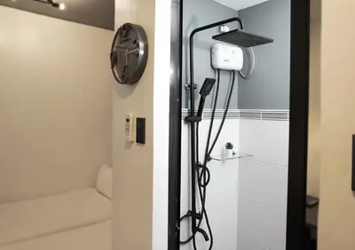 a shower in a bathroom with a toilet and a shower at mySTAY Hotel BGC East in Manila