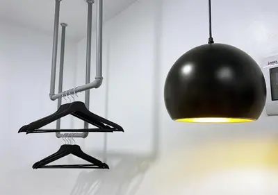 a blackendant light and a black ball hanging from a wall at mySTAY Hotel BGC East in Manila