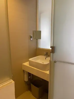 a bathroom with a sink and a mirror at Wow Budget Hotel Cubao in Manila