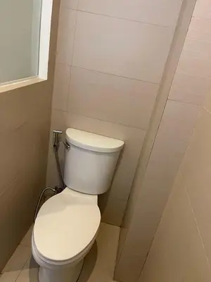 a bathroom with a white toilet in a room at Wow Budget Hotel Cubao in Manila