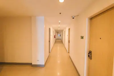 an empty hallway in a building with a long corridor at Wow Budget Hotel Cubao in Manila