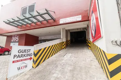 a building with a exit parking sign and a police parking entrance at Wow Budget Hotel Cubao in Manila