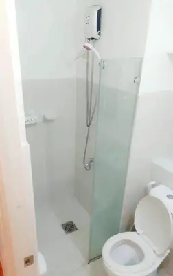 a bathroom with a shower and a toilet at The Linear Makati Condo Stunning Hotel Type Interior in Manila
