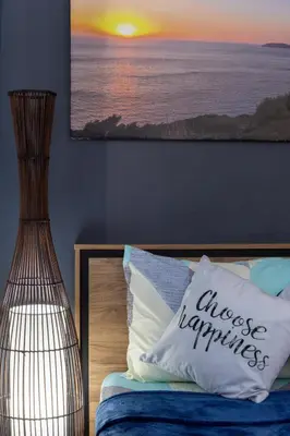 a bedroom with a bed with a pillow with the words choose happiness at Bella Vita at Grace Residences in Manila