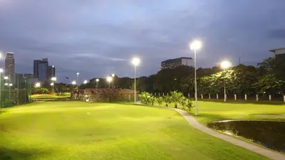 a golf course at night with a city in the background at USA embassy front suite Pearl of the Orient in Manila