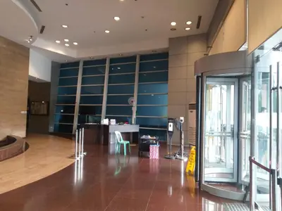 a lobby with blue cabinets and a table in a building at USA embassy front suite Pearl of the Orient in Manila
