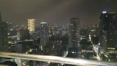 a view of a city skyline at night at USA embassy front suite Pearl of the Orient in Manila