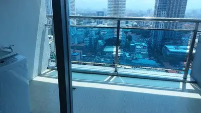 a view of a city skyline from a window at MANILA BAY FRONT DELUX Pearl of the orient in Manila