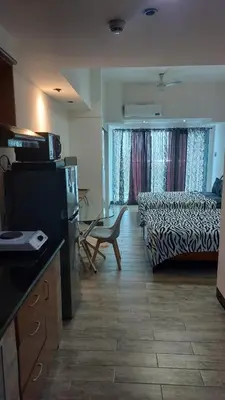 a kitchen and living room with a bed and a couch at MANILA BAY FRONT DELUX Pearl of the orient in Manila