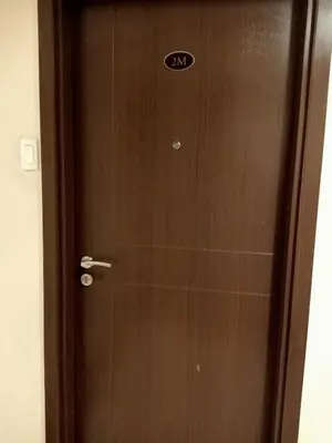 a wooden door with a sign on it at Taj's Condotel in Manila