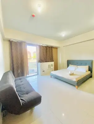 a large bedroom with a bed and a couch at Hotel Type Condo Near NAIA Manila Airport in Manila