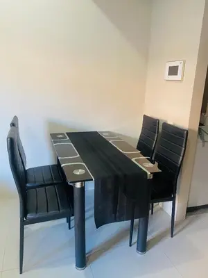 a black table with black chairs in a room at Hotel Type Condo Near NAIA Manila Airport in Manila