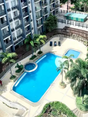 an overhead view of a swimming pool with palm trees at Hotel Type Condo Near NAIA Manila Airport in Manila