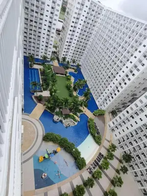 an aerial view of a park in the middle of two tall buildings at Shore Residence D1,shortwalk MALL OF ASIA near airport wifi in Manila