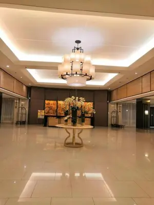 a large lobby with a table and a chandelier at Shore Residence D1,shortwalk MALL OF ASIA near airport wifi in Manila