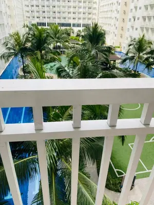 a view from the balcony of a building with palm trees at Shore Residence D1,shortwalk MALL OF ASIA near airport wifi in Manila