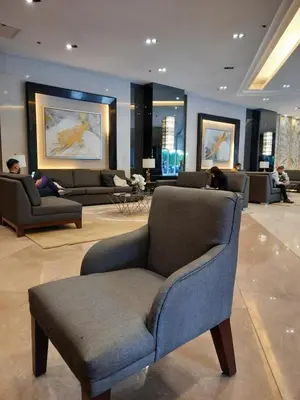a lobby with a chair and couches in a building at SMDC FAME Residences David 's place in Manila