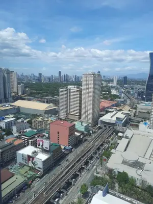 an aerial view of a city with buildings and roads at SMDC FAME Residences David 's place in Manila