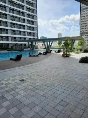 a bridge over a pool in a city with buildings at SMDC FAME Residences David 's place in Manila