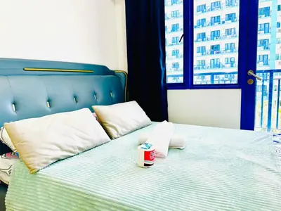 a bed with a cup of coffee sitting on it at Sea Residences Tower F Angel 0975 - 811 - 9490 in Manila