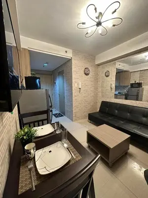 a living room with a couch and a table at Sabina's one bedroom condo at Shore tower C in Manila