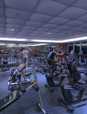 a gym with a lot of exercise bikes in a room at Sabina's one bedroom condo at Shore tower C in Manila