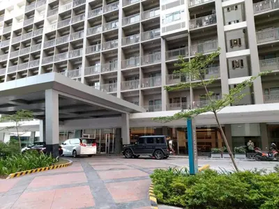 a parking lot in front of a large building at Sabina's one bedroom condo at Shore tower C in Manila