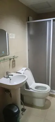 a bathroom with a toilet and a sink at 18F staycation in Manila