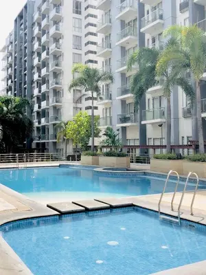 a swimming pool in front of a large apartment building at Luxury Hotel Type Condo Near NAIA Manila Airport in Manila