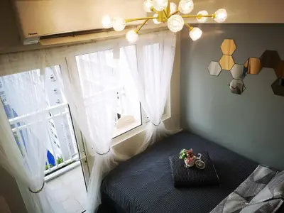 a bedroom with a bed and a large window at Shore Residences Mall of Asia Pool View 200mbps Free Wi-Fi in Manila