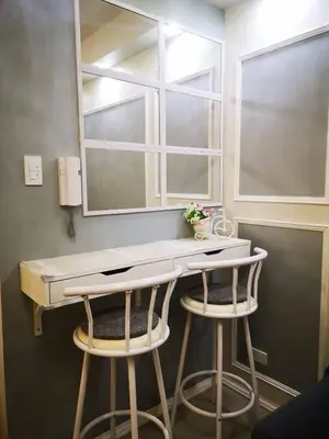 a bathroom with a vanity with two stools and a mirror at Shore Residences Mall of Asia Pool View 200mbps Free Wi-Fi in Manila