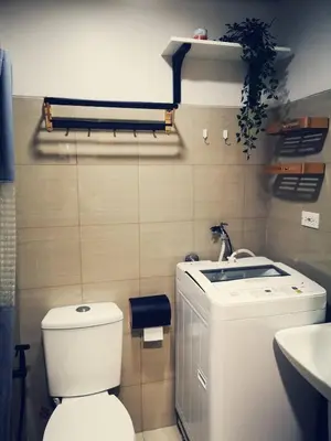 a bathroom with a toilet and a sink at Shore Residences Mall of Asia Pool View 200mbps Free Wi-Fi in Manila