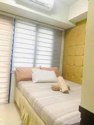 a bed in a room with a window at Sea Residences - Property Val Alano 0995-448-8872 in Manila