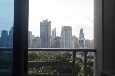 a view of a city skyline from a window at A2J Luxury 1BR BGC Balcony Suite Near BurgosCircle in Manila