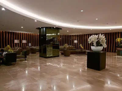 a lobby with a glass elevator in a building at Home away from Home in Manila
